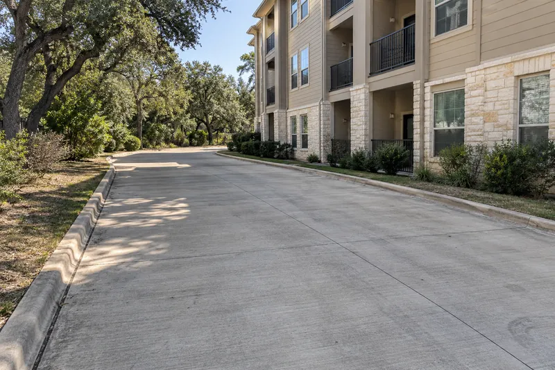 Apartment Concrete in Waco, TX, example photo: concrete fire lane beside a multi-storey apartment building