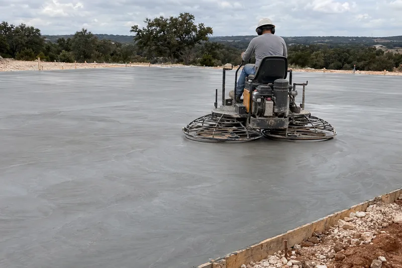 Commercial Concrete in Beverly Hills, TX, example photo: ride-on power trowel finishing a large concrete slab