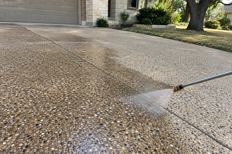 Concrete Contractor in Riesel, TX, example photo: a sprayer applying clear sealer to an exposed-aggregate driveway