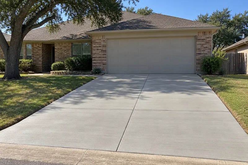 Concrete Driveways in Abbott, TX, example photo: broom-finished two-car concrete driveway with saw-cut control joints