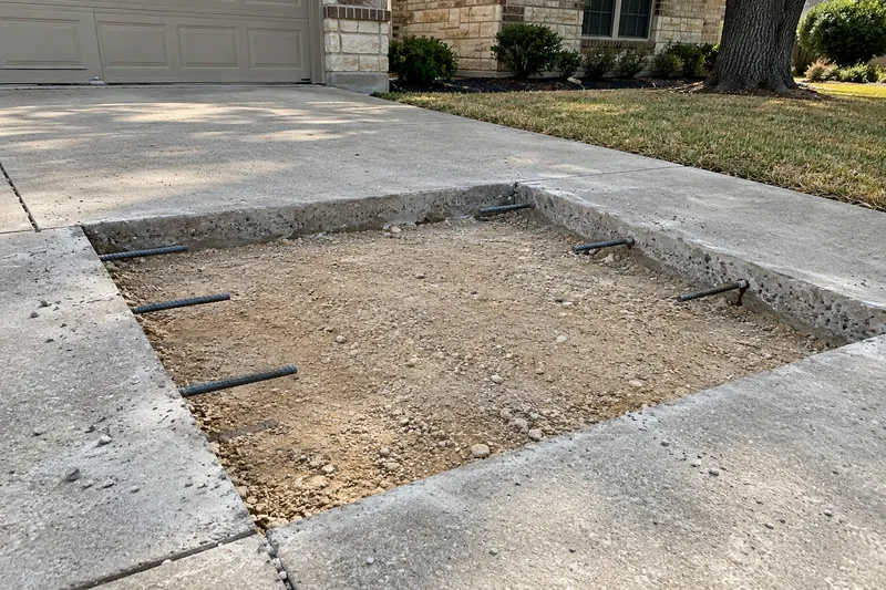Concrete Driveways in Riesel, TX, example photo: driveway panel saw-cut out, with dowels drilled into the old edge