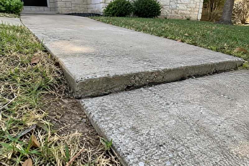 Concrete Leveling in Waco, TX, example photo: walkway slab sunk below the next slab, with a gap at the joint