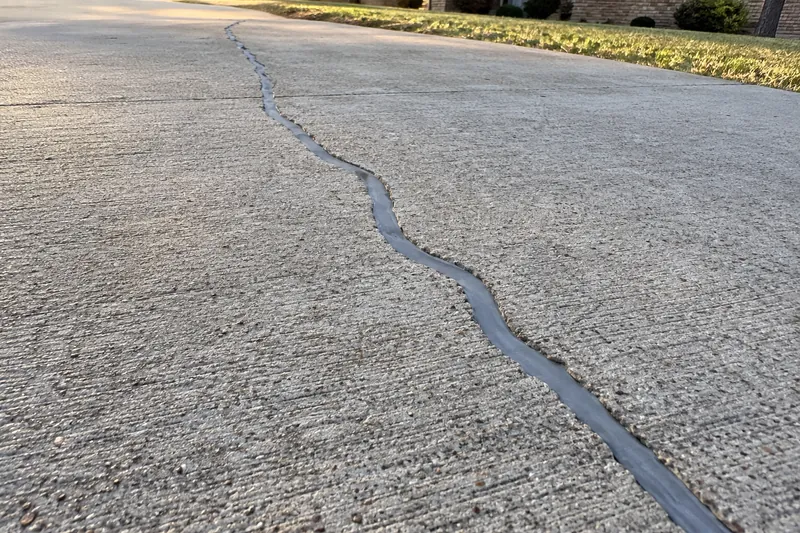 Concrete Repair in Moody, TX, example photo: driveway crack routed and filled with gray sealant